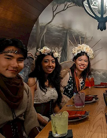 A group of friends in costume dine in Blade & Barrel Tavern